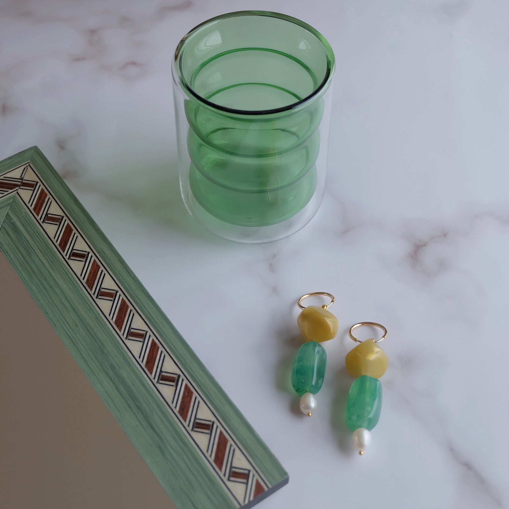 Green glass tumbler selected by Atelier N°8
