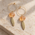 LULA Apricot Glow Earrings with apricot-coloured beads and textured gold-tone leaf charms