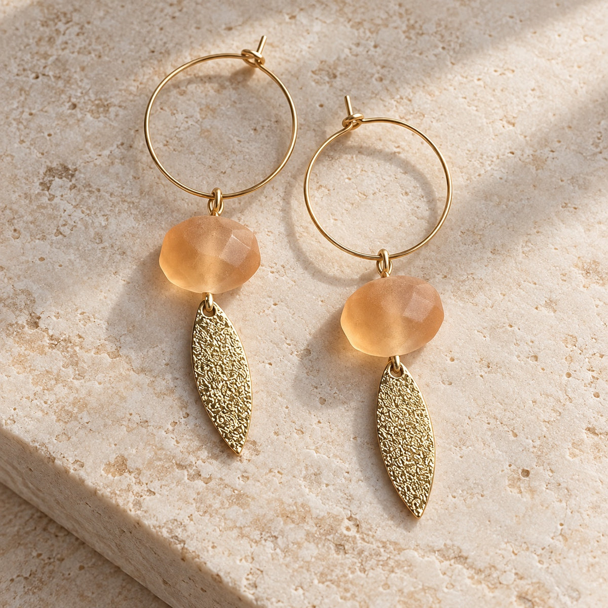 LULA Apricot Glow Earrings with apricot-coloured beads and textured gold-tone leaf charms
