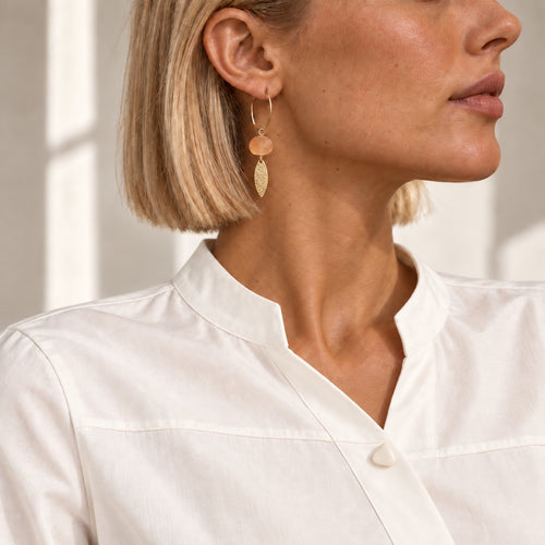 LULA Apricot Glow Earrings worn with a white shirt