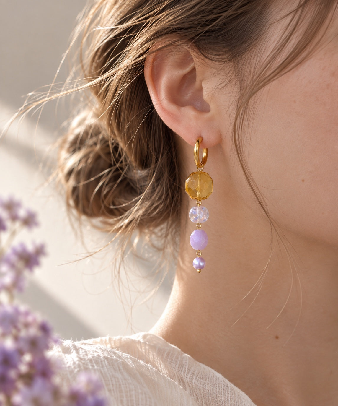 Model wearing LULA Aurora handmade amber and lilac glass earrings