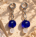 LULA Cobalt Drop Earrings — pair displayed on a warm stone surface